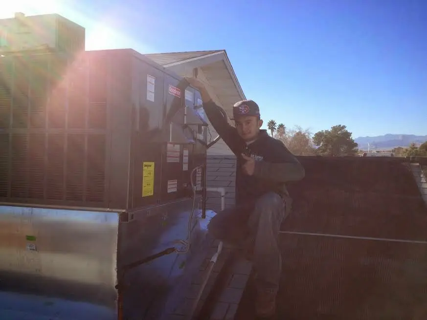 HVAC technician performing HVAC Inspection on a rooftop unit in Rolling Meadows